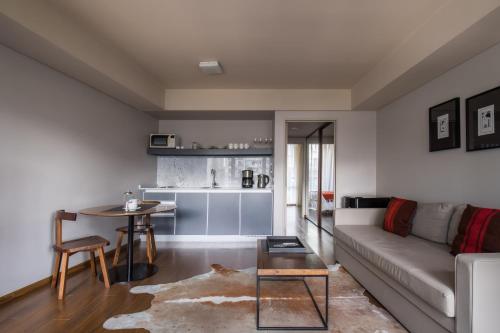 a living room with a couch and a table at Palermo Soho Square in Buenos Aires