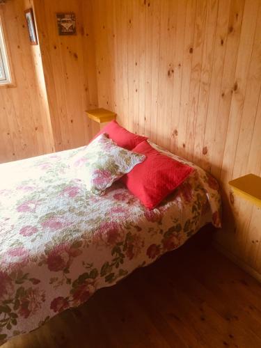 a bedroom with a bed with two pillows on it at Dulac Futrono in Futrono