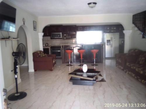 a living room with a couch and a table at Eve's Rockaway Villa in Alligator Pond Village