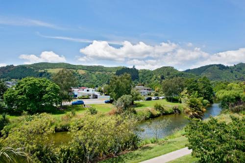a view of a river with trees and a town at Waimarie on Riverside Motel & Apartments in Nelson