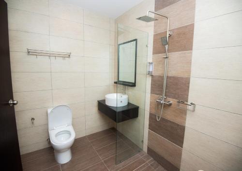 a bathroom with a toilet and a shower at MOLEK REGENCY TAMAN MOLEK in Johor Bahru