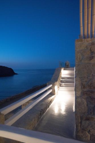 a view of the ocean from a wall with lights at Merchia Bay Villas Mykonos in Merchia Beach