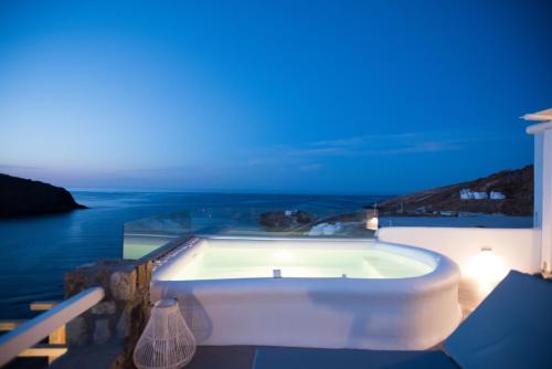 a white bath tub sitting on the side of a building at Merchia Bay Villas Mykonos in Merchia Beach