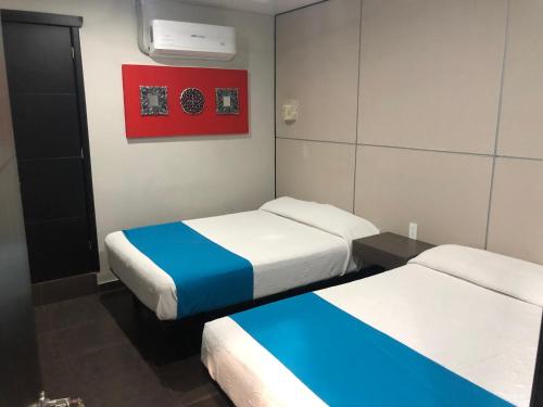Katil atau katil-katil dalam bilik di Hotel Raga Inn