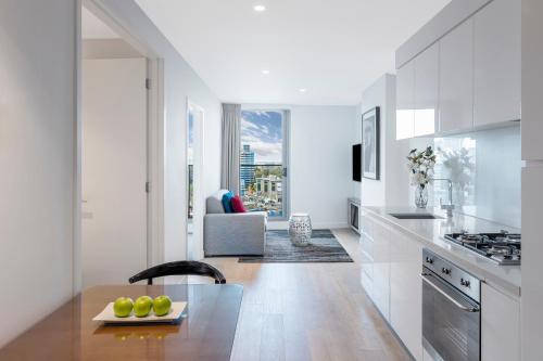 a kitchen with a stove, refrigerator, sink, and dishwasher at Imagine Marco in Melbourne
