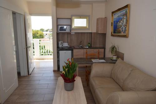 a living room with a couch and a table at Antonis G. Hotel Apartments in Voroklini