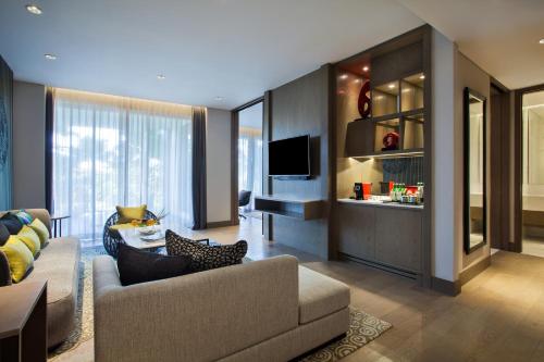 a living room with a couch and a tv at Pullman Ciawi Vimala Hills Resort in Bogor