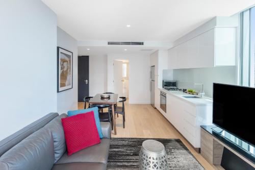 a living room with a couch and a table at Imagine Marco in Melbourne