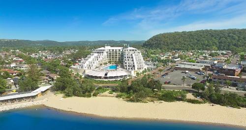 an aerial view of a large building next to the water at Ettalong Beach Luxury Apartments in Ettalong Beach