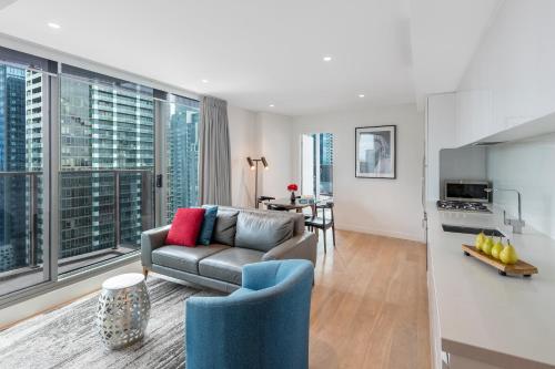 a living room with a couch and a kitchen at Imagine Marco in Melbourne
