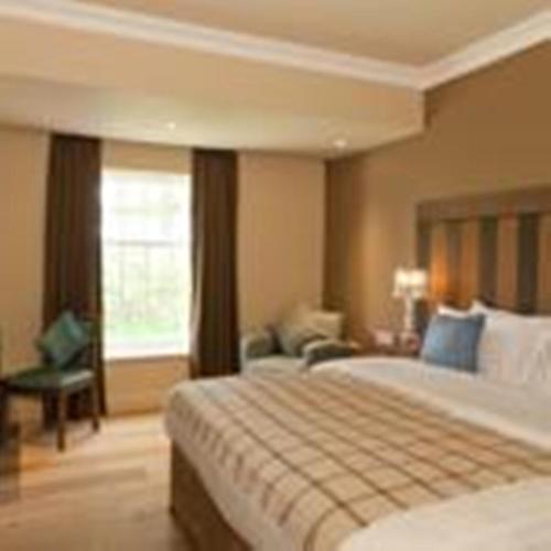 a hotel room with two beds and a window at Spa Hotel at Ribby Hall Village in Wrea Green