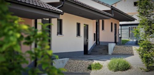 a house with a front door and stairs to it at Penzion U Křížku in Kobylí