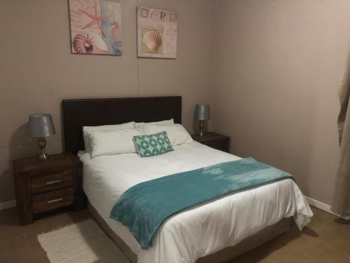 a bedroom with a bed with two night stands and two lamps at Quayside 1001 Durban Point in Durban