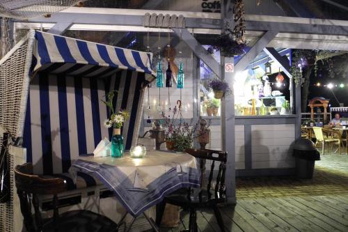 a table with a striped canopy in a restaurant at SeaPark Hotel Wellness & Spa in Kołobrzeg