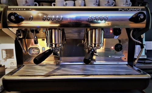 a coffee machine with two spoons in it at Penzion U Křížku in Kobylí