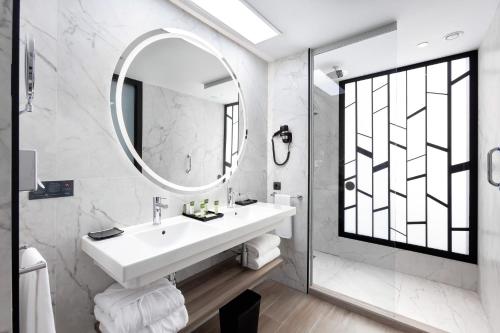 a bathroom with a sink and a mirror at Hotel Riu Palace Oasis in Maspalomas