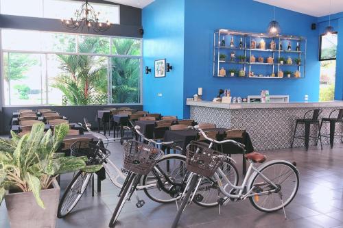 a row of bikes sitting in a kitchen next to a window at The Malika Hotel - SHA Extra Plus in Phuket Town