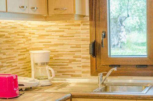 a kitchen with a coffee maker and a sink at Chrisella Villa in Skala Rachoniou