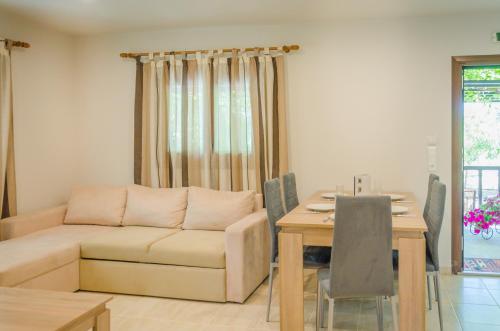 a living room with a couch and a table at Chrisella Villa in Skala Rachoniou