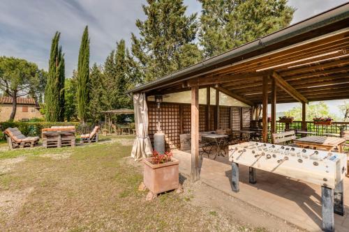 a pavilion with a table and chairs in a yard at Podere Casanova in Montespertoli