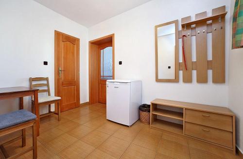 a kitchen with a white refrigerator and a table at Penzion Kříž in Český Krumlov