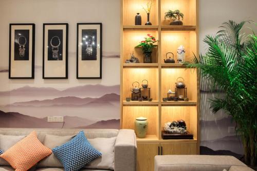 a living room with a couch and pictures on the wall at Li River Resort Villa Hotel in Guilin
