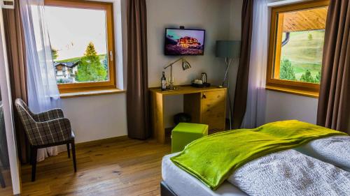 a bedroom with a bed and a window at Sport Hotel in Livigno