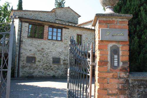 an entrance to a stone house with a wrought iron gate at Villa La Nussa in Capolona