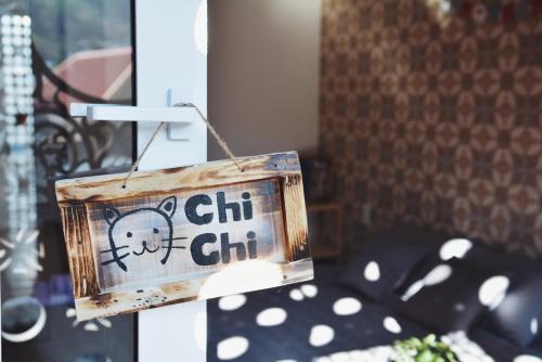 a wooden sign hanging on the side of a building at Mochi's Home in Vung Tau