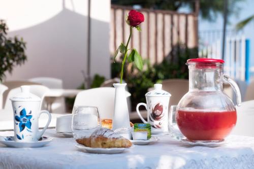 a table with a vase with a red liquid in it at Hotel Mediterraneo in Lido di Latina 