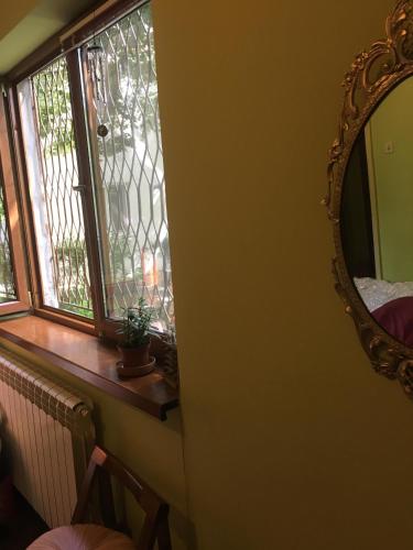 a mirror on a wall next to a window at Sara’s place in Constanţa