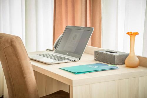 a laptop computer sitting on top of a desk at Hotel Mar Garni in Belgrade