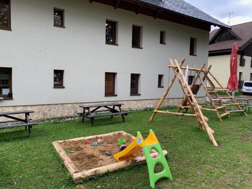 a park with a sandbox and a play set at Penzion Sunski in Harrachov