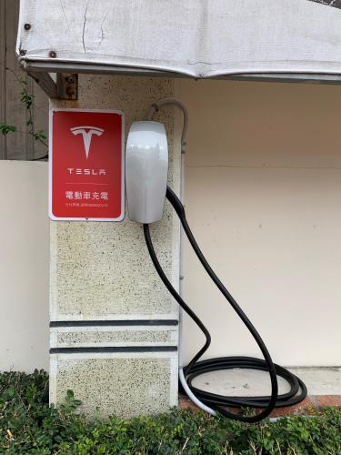 a tesla phone is plugged into a wall at Chia Shih Pao Hotel in Taibao