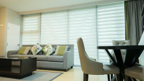 a living room with a couch and a table at Avant Serviced Suites - Personal Concierge in Manila