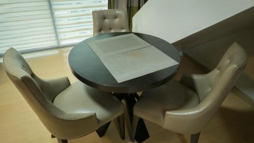 a black table with chairs and a box on it at Avant Serviced Suites - Personal Concierge in Manila
