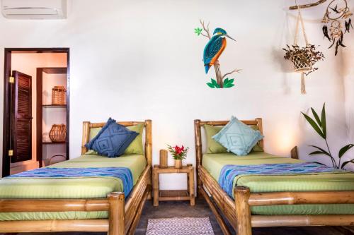 a room with two beds and a mirror at Three Little Birds Resort in Anda
