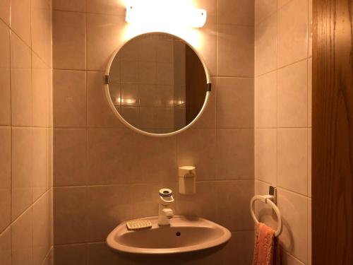 a bathroom with a sink and a mirror at Gasthof Zur Krone in Leidersbach