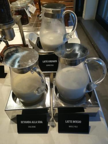 two pitchers of milk on display in a store at Best Western Hotel Rome Airport in Fiumicino