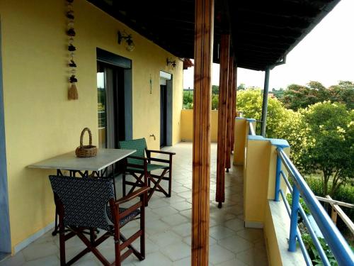 a patio with chairs and a table on a balcony at Nice house by the sea! in Epanomi