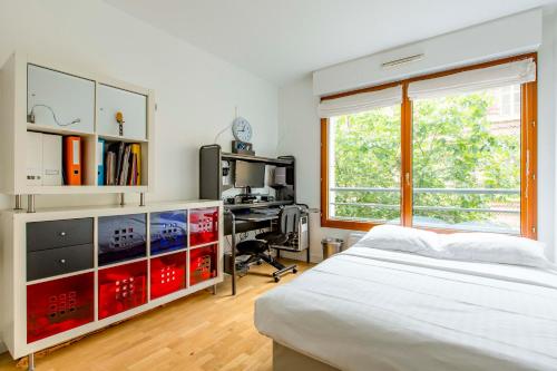 une chambre avec un lit, un bureau et une fenêtre dans l'établissement Veeve - Modern Brights, à Paris
