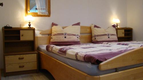 um quarto com uma cama com duas almofadas em Ferienwohnung Heidi em Altena