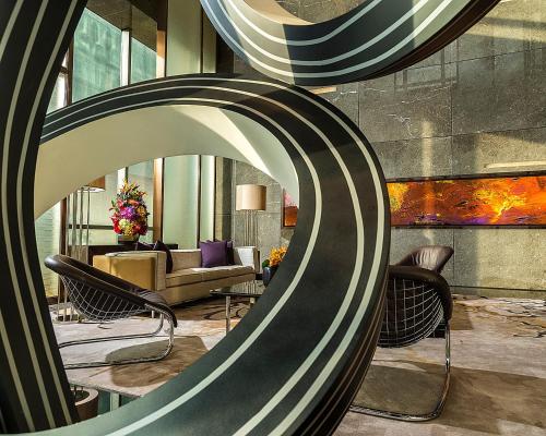 a lobby with chairs and a couch in a room at Four Seasons Hotel Shenzhen in Shenzhen