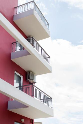 a building with balconies on the side of it at Snooze H in Athens