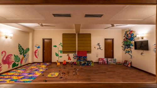 a room with a large wooden floor with paintings on the walls at 8fold by LaRiSa in Shimla