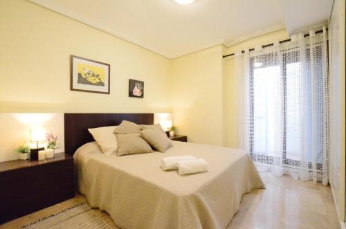 a bedroom with a bed with two towels on it at City Center Apartment in Valencia
