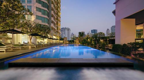 a swimming pool in the middle of a building at JC Kevin Sathorn Bangkok Hotel in Bangkok