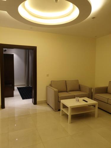 a living room with two couches and a coffee table at Lamar Al Bawadi Hotel in Jeddah