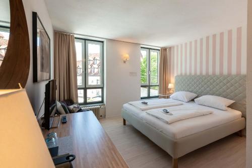 a bedroom with a large bed in a room at Hotel Am Dom in Bamberg