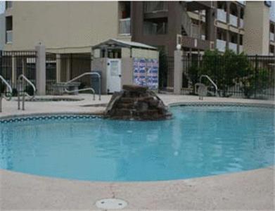 a large blue swimming pool in front of a building at Days Inn by Wyndham Corpus Christi Beach in Corpus Christi